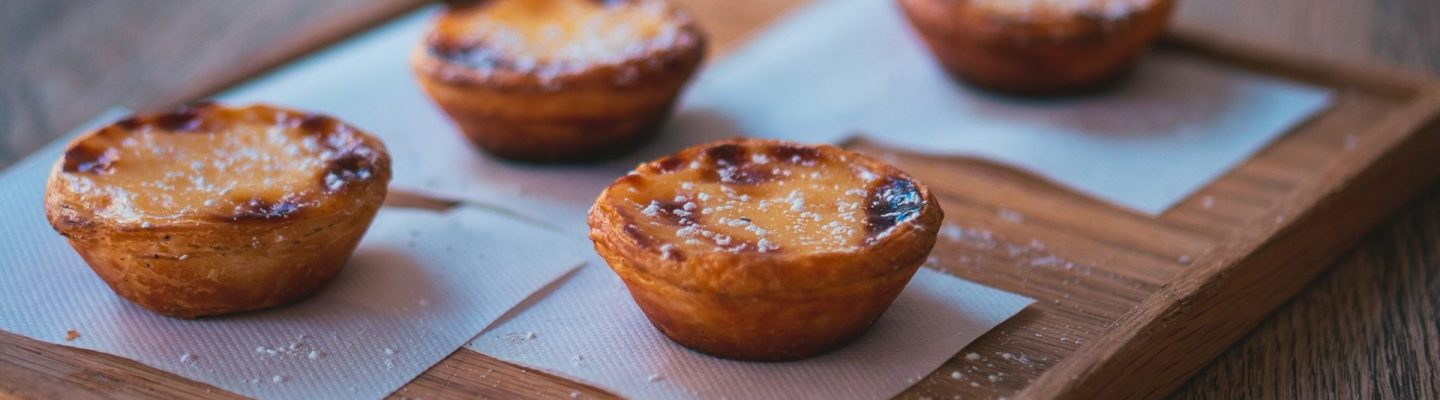 Pastel de Nata Four freshly baked Pasteis de Nata, traditional portuguese egg custards