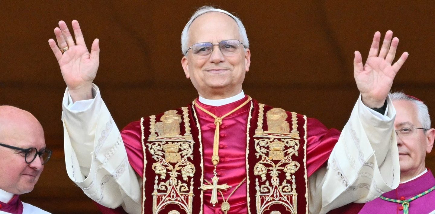 People Leo Xiv praising with his arms and hands open in a red catholic prist robe